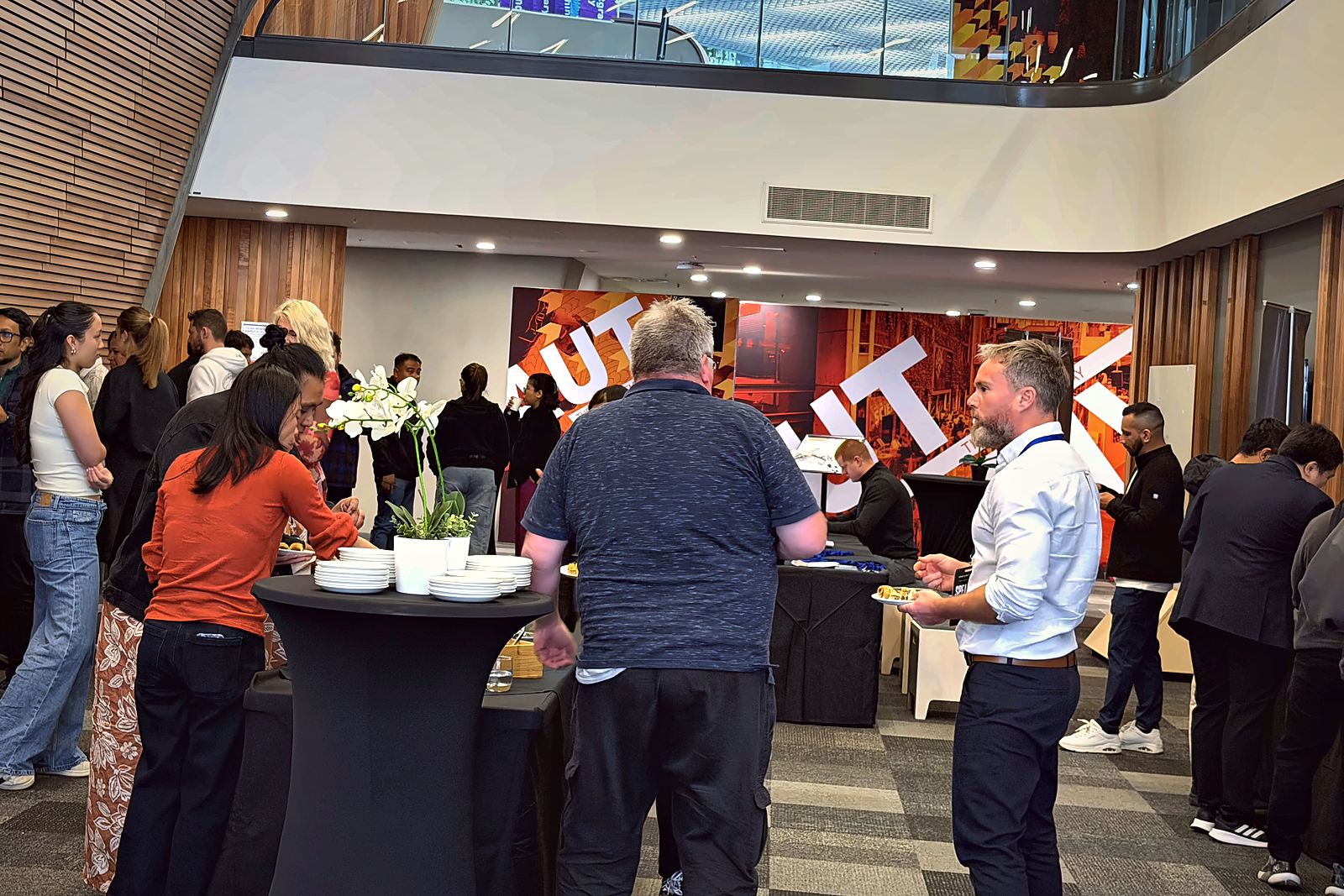 Delegates networking over refreshments at AUT during Comedy Summit Global 2026